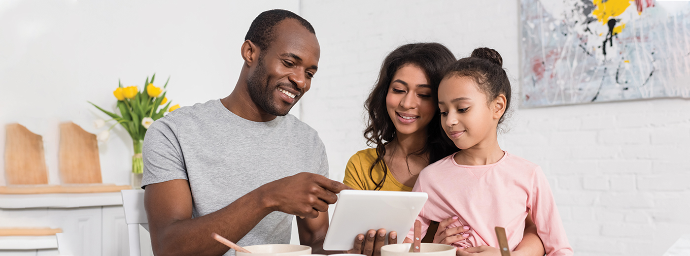 Family looking at tablet together